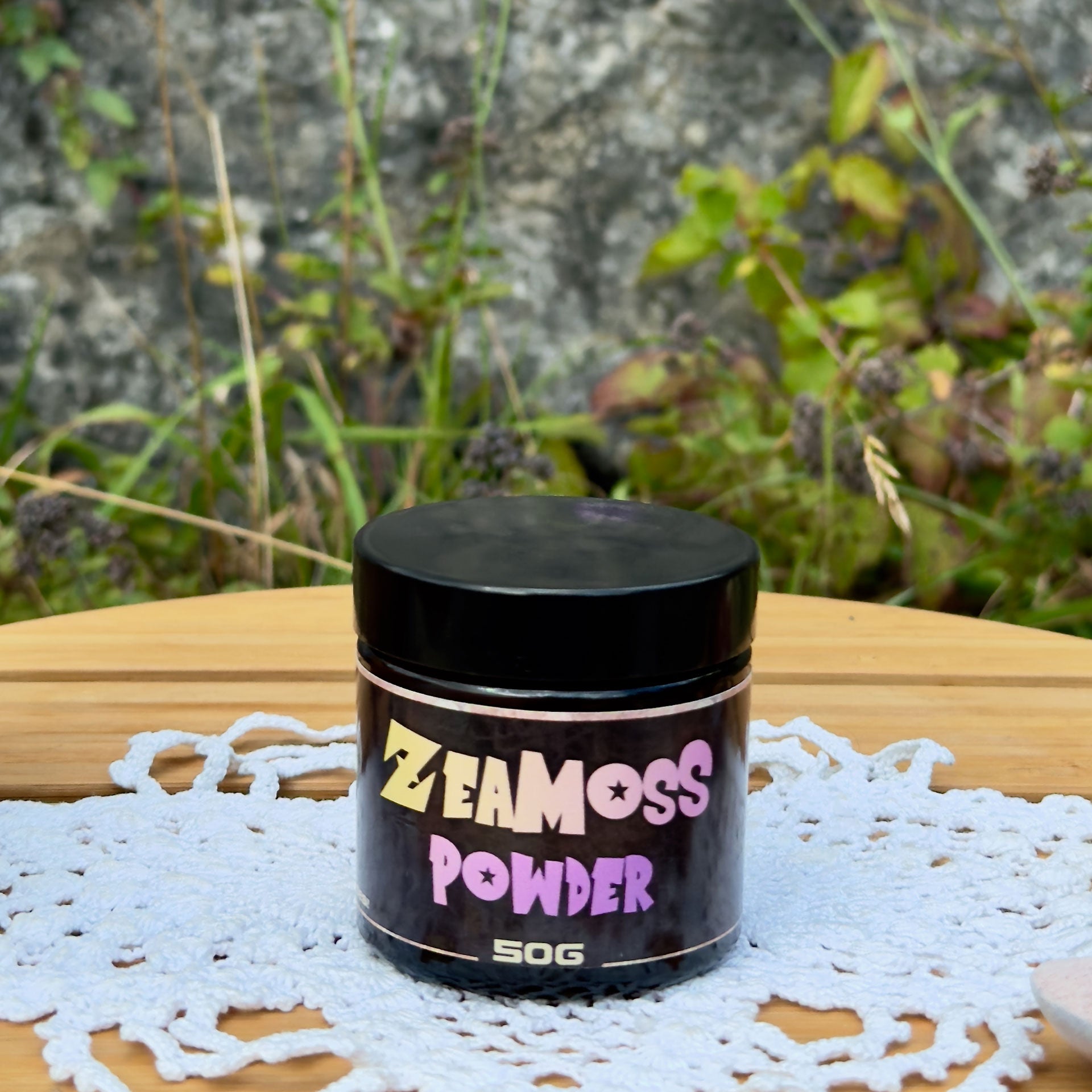 Rainbow Wildcrafted African Sea Moss Pulver (Euchema Denticulatum), 50g Glas von ZeaMoss, Closeup Bild, präsentiert draußen vor einer Naturkulisse